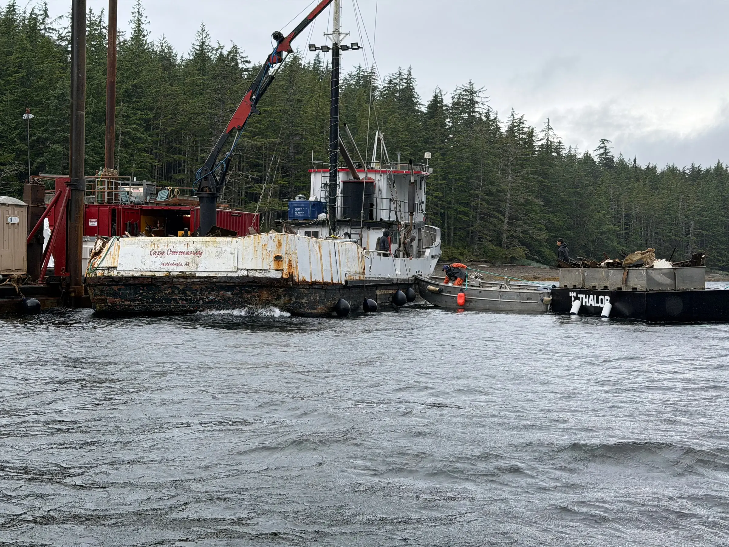 A Thalor work platform beside the Cape Ommaney cleanup as crews work between the vessel, skiff and crane barge.